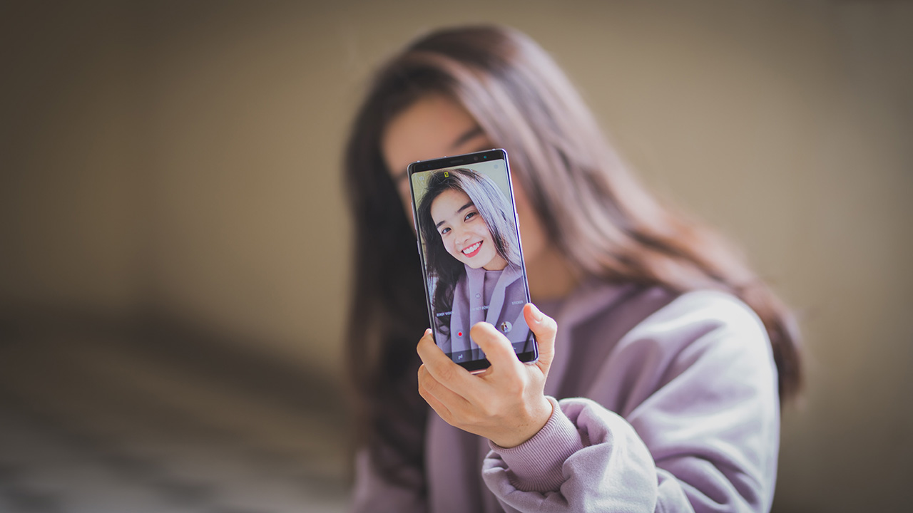girl taking a selfie on a phone