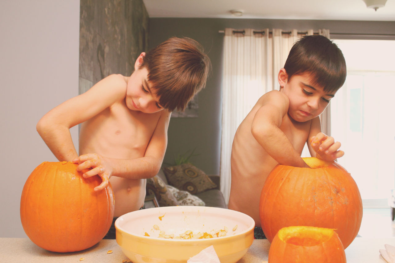 boys carving pumpkin
