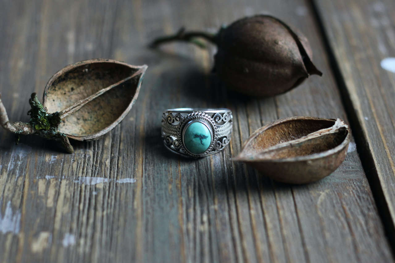 silver ring on wooden table