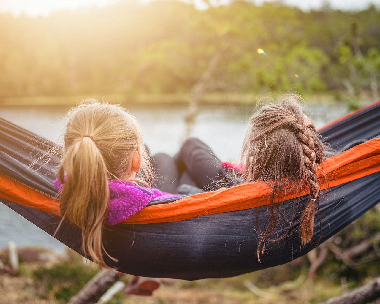 two friends chilling in a hammock