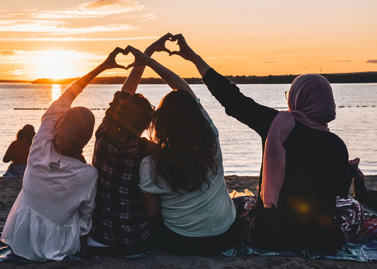 friends making heart sign