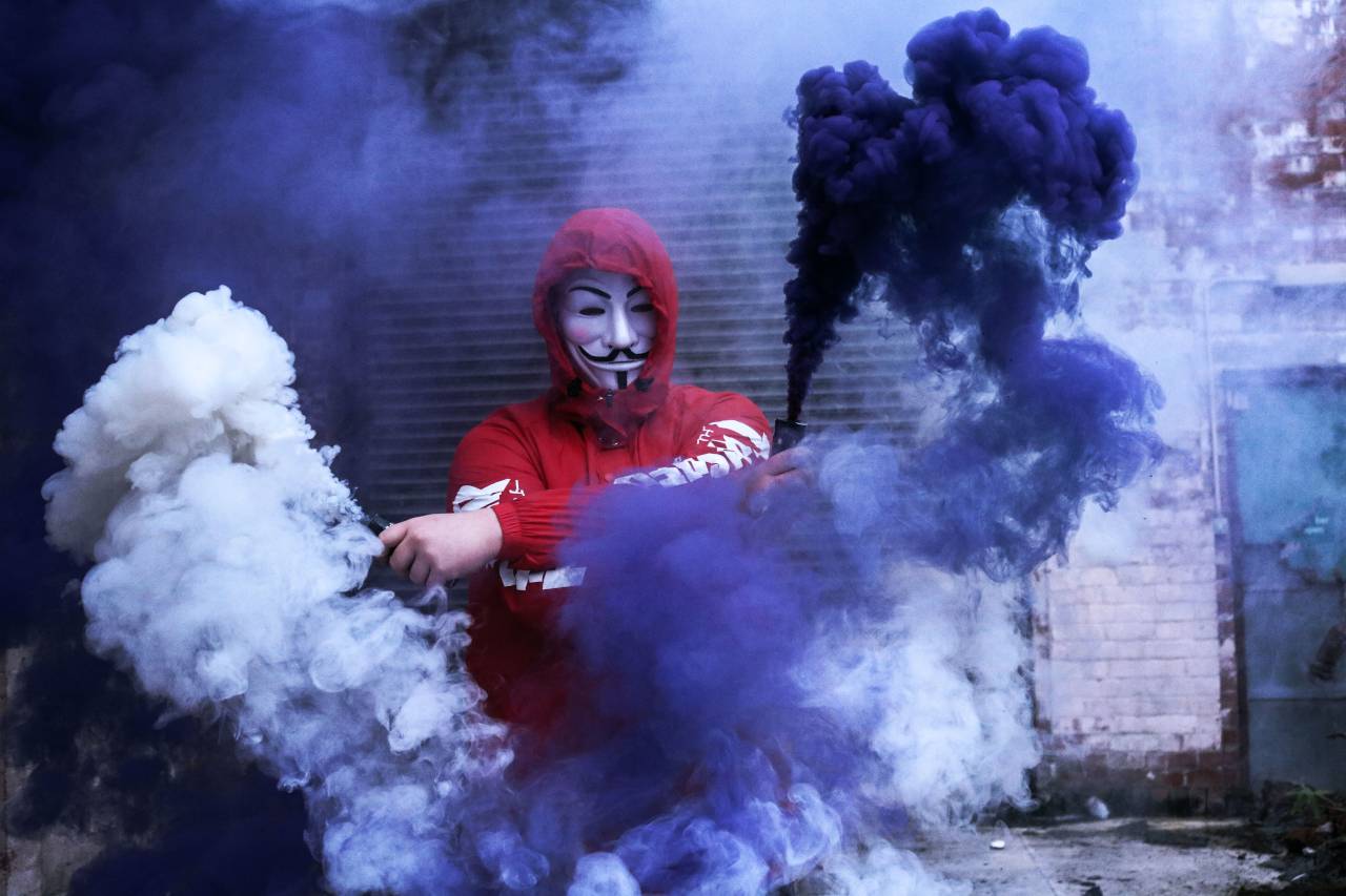 smoke bomb photography in area with wind shelter