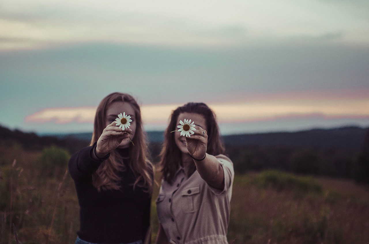 best friends holding flower