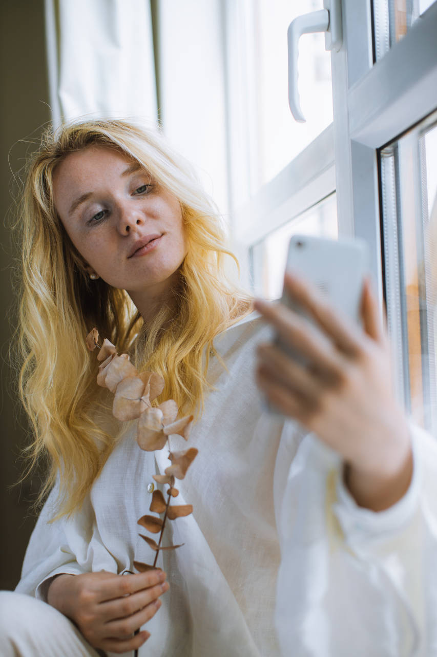 selfie pose near a window