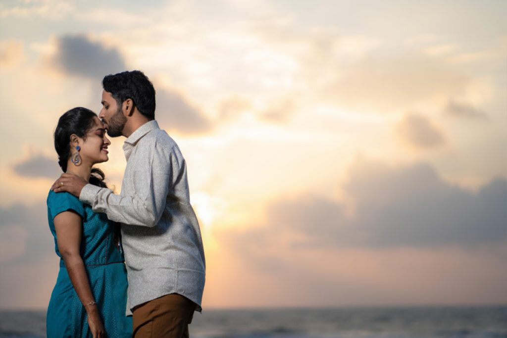 girlfriend in pink dress and handsome boyfriend in denim shirt hugging and  looking at each other Stock Photo by LightFieldStudios